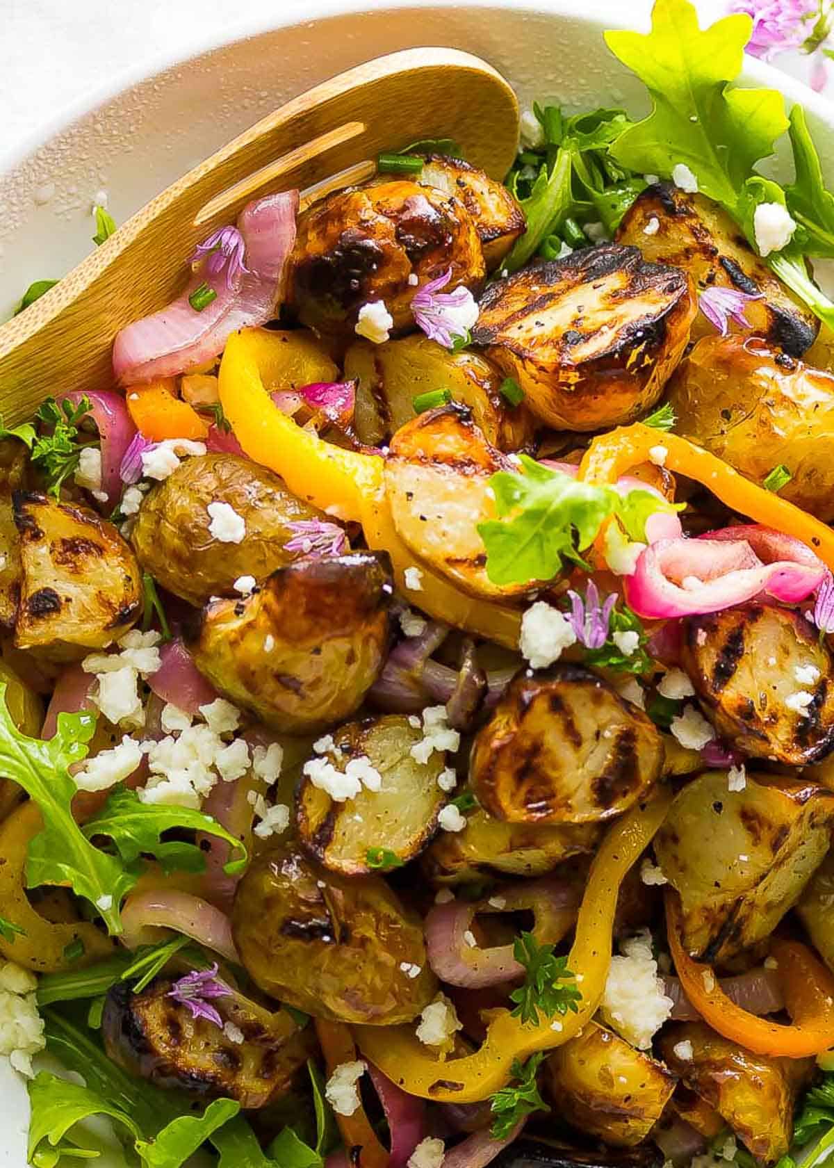 hearty grilled potato salad with peppers, onions, feta, and arugula