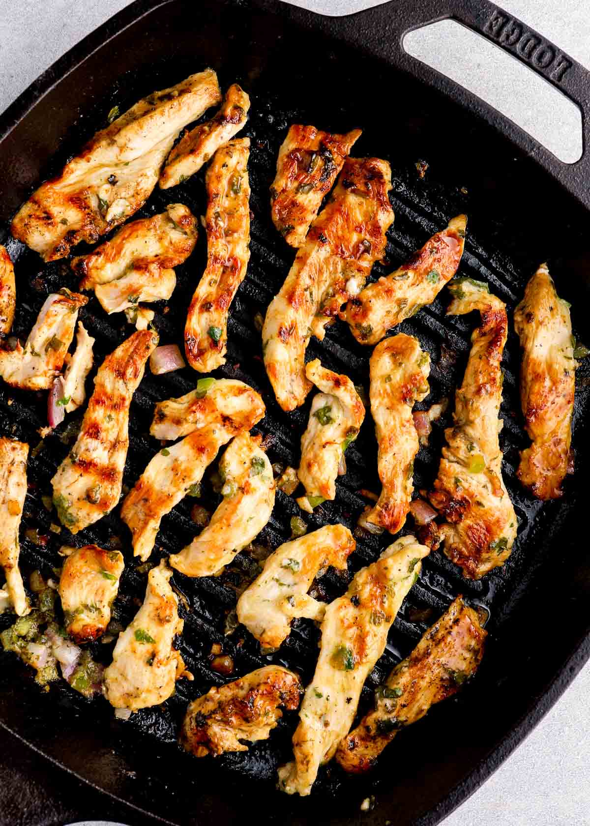 golden brown fajita chicken cooking in a pan