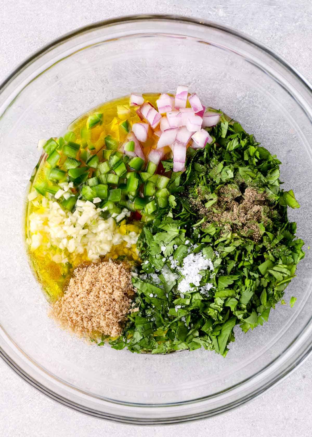 oil, garlic, jalapeno, onion, cilantro, sweetener, salt, and pepper in a glass bowl