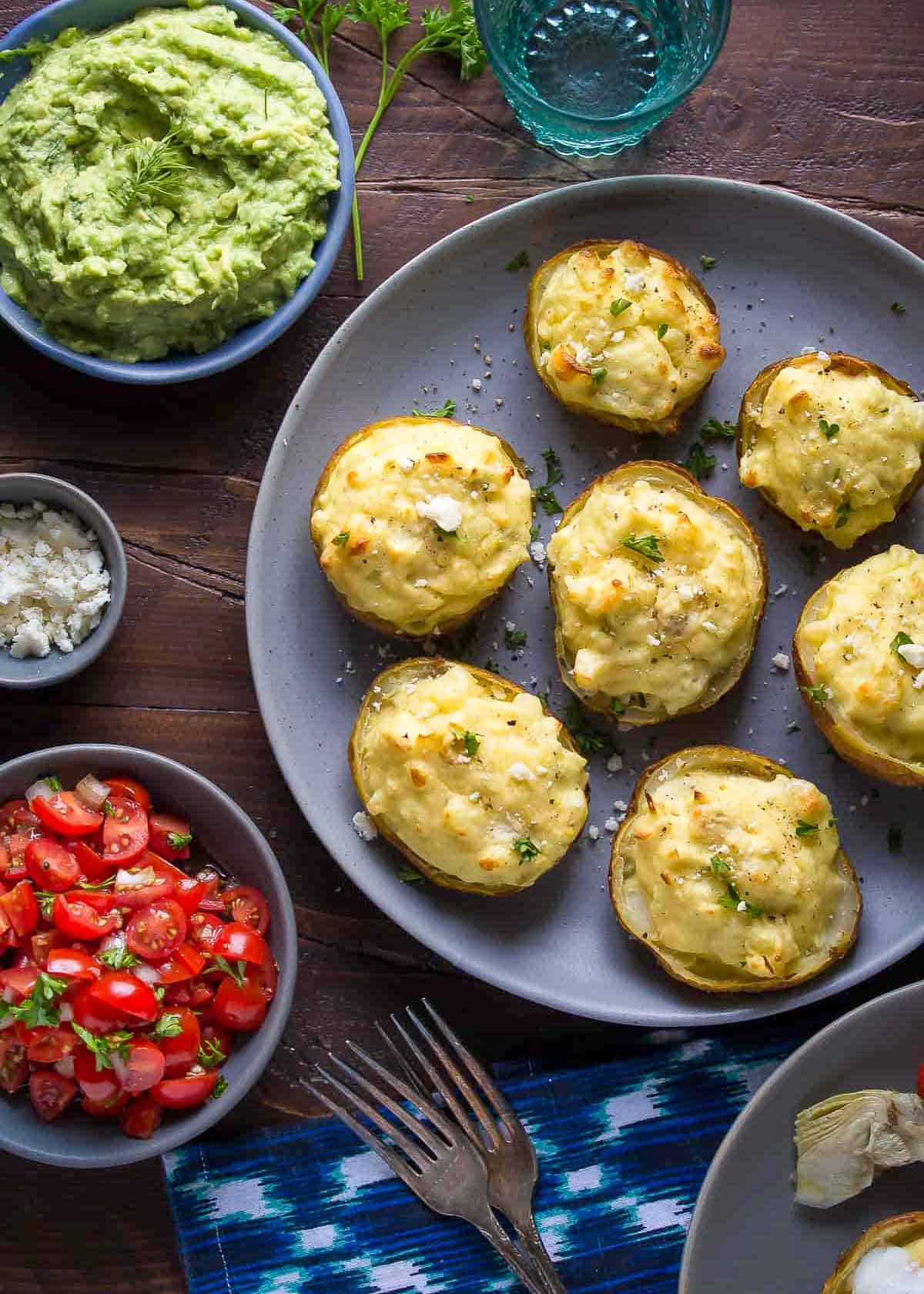 brunch platter with mediterranean twice baked potatoes beside optional toppings: tomato bruschetta and avocado mash