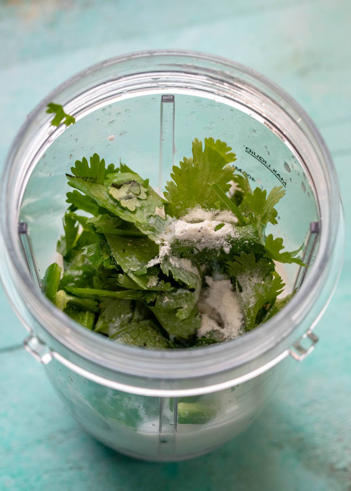 cilantro, milk, yogurt, ranch dressing mix, lime juice, and jalapenos in a blender cup