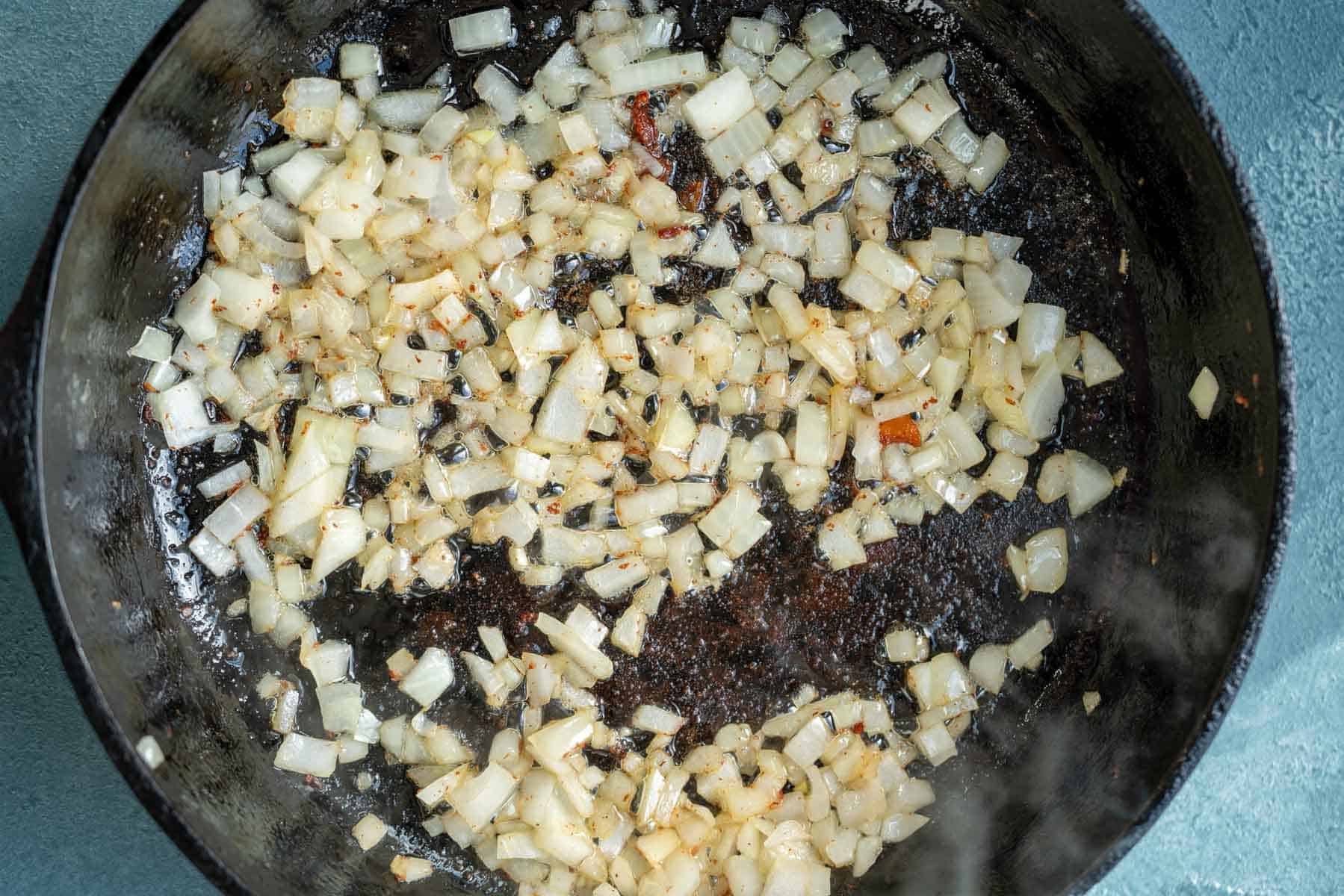 diced onion softening in a pan