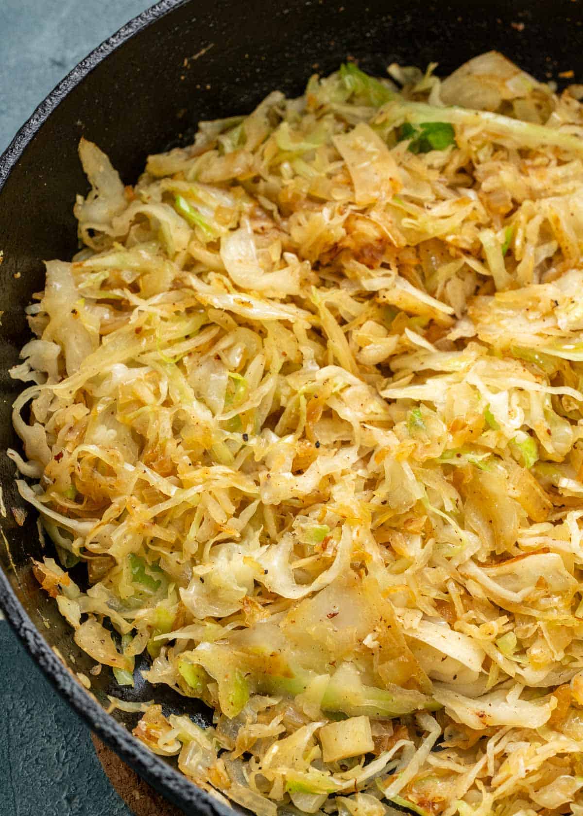 fried cabbage with softened onions in a pan