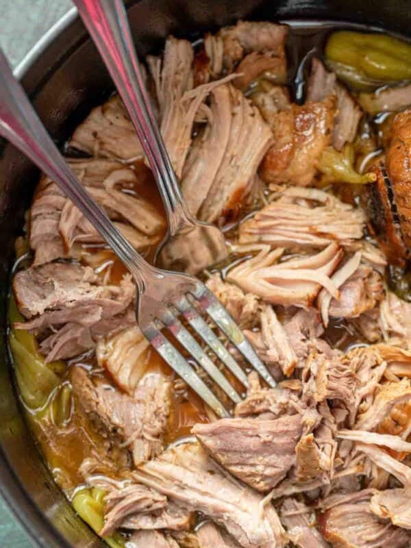 Juicy pork sirloin roast shredded in a pot