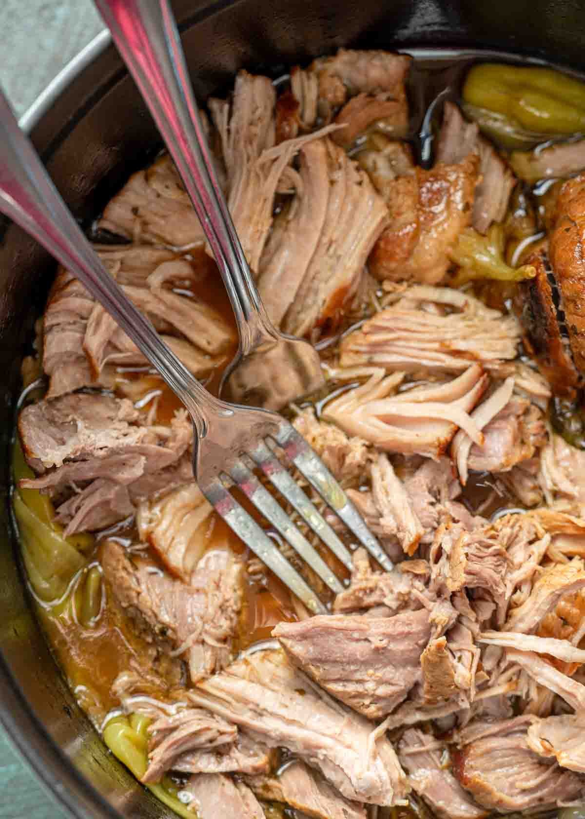 Juicy pork sirloin roast shredded in a pot