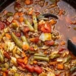 overhead image of hamburger soup with cabbage in black dutch oven