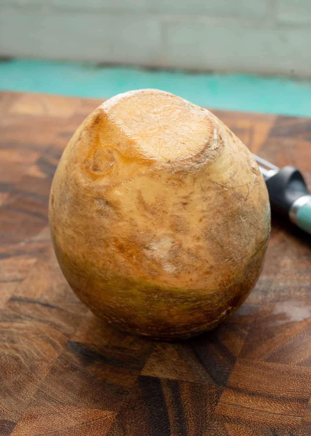 a whole rutabaga on a cutting board