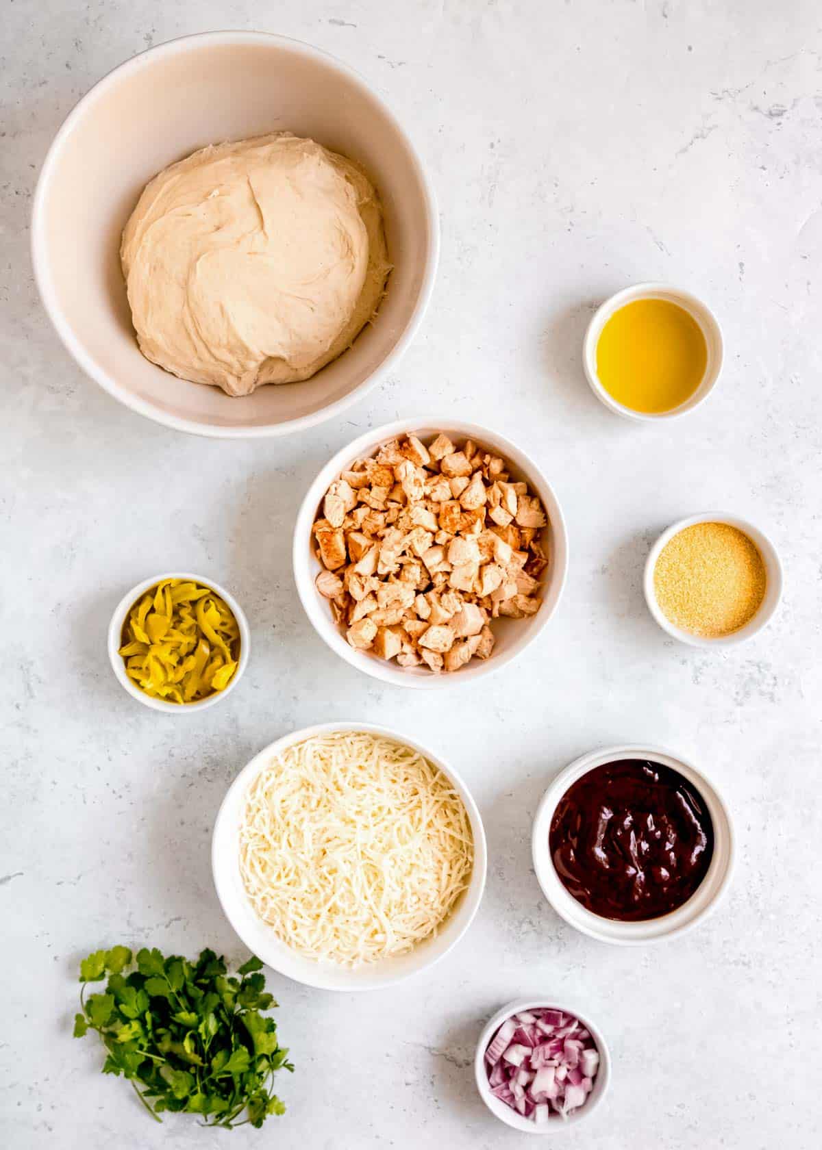 ingredients for BBQ chicken pizza on a counter