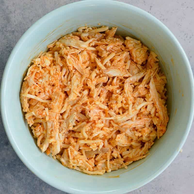 shredded buffalo chicken in a white bowl