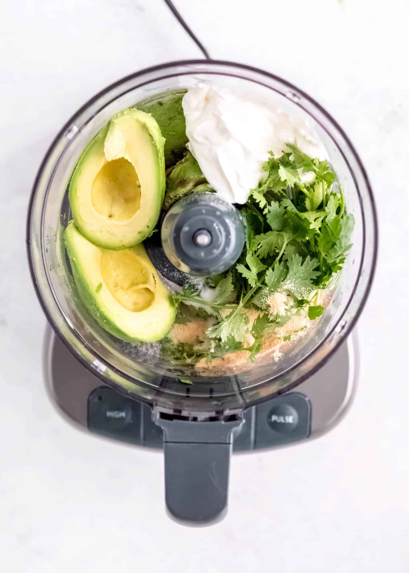 avocados, cilantro, sour cream, and seasonings in a food processor