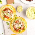 crispy chicken tostadas on a board with avocado crema