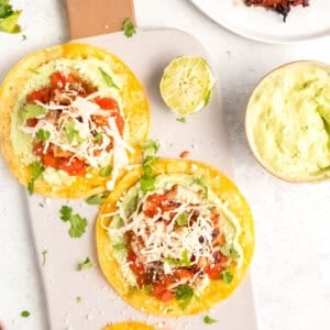 crispy chicken tostadas on a board with avocado crema