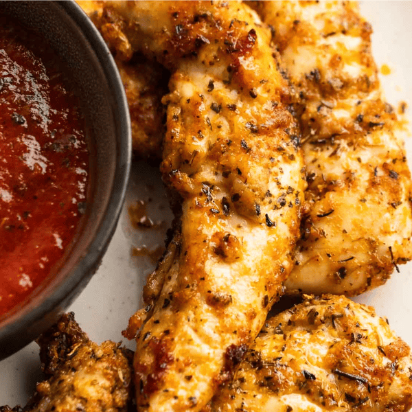 air fryer chicken tenderloins with a side of dipping sauce; text overlay "THE BEST AIR FRYER CHICKEN RECIPES"