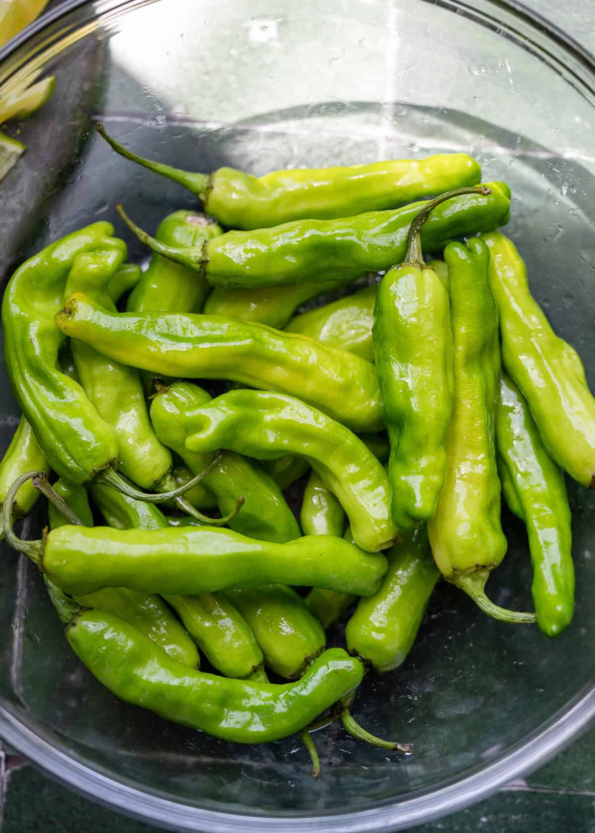 whole shishito peppers coated in oil